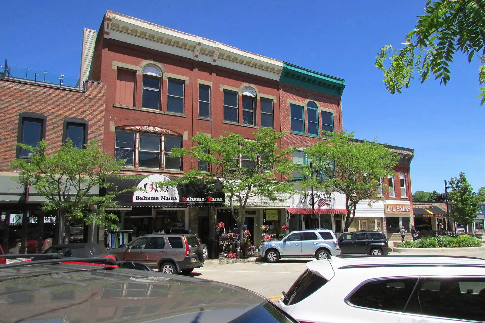 Historic brick storefronts on a sunny downtown street