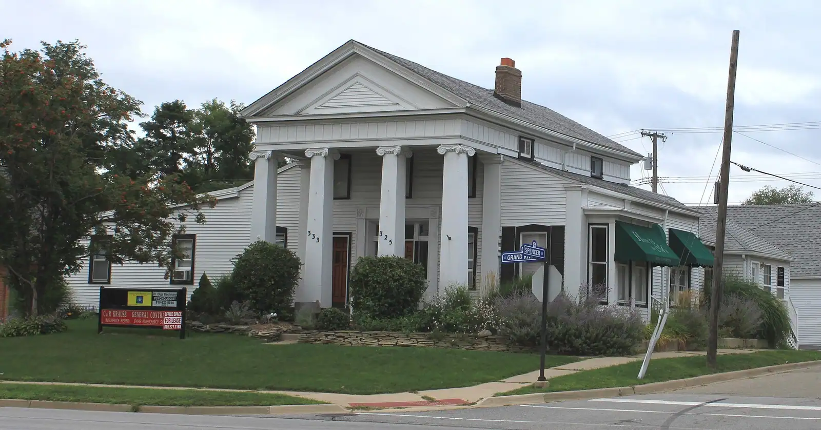 A white Greek Revival house with columns