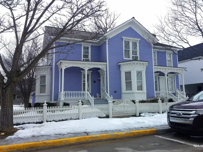 A blue Victorian-style house with a porch