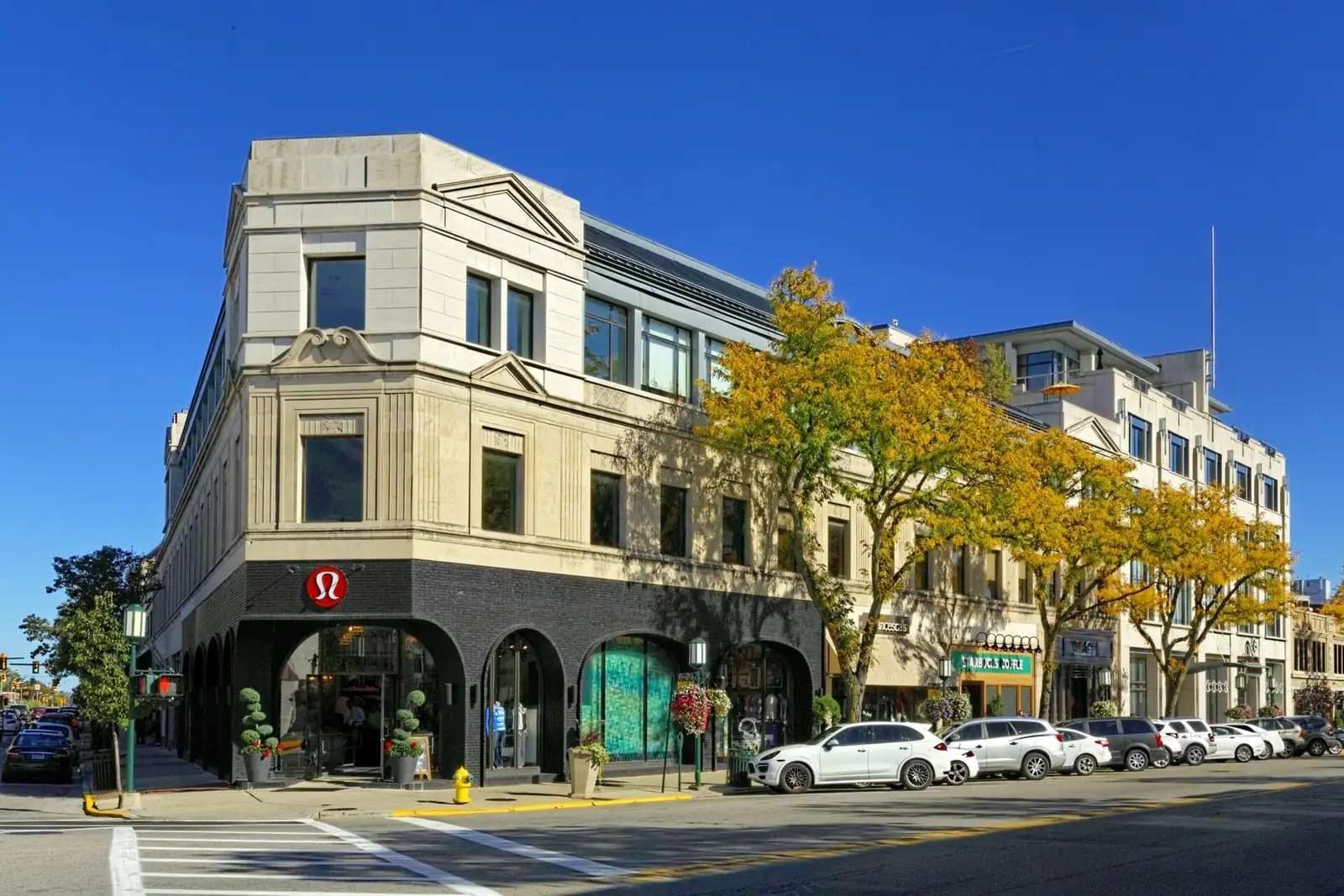 Shops along a downtown street with fall trees