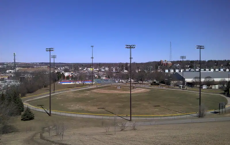 An open park on a hillside with the city beyond