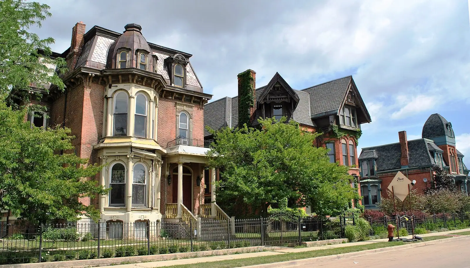 Restored Victorian brick mansions under a blue sky