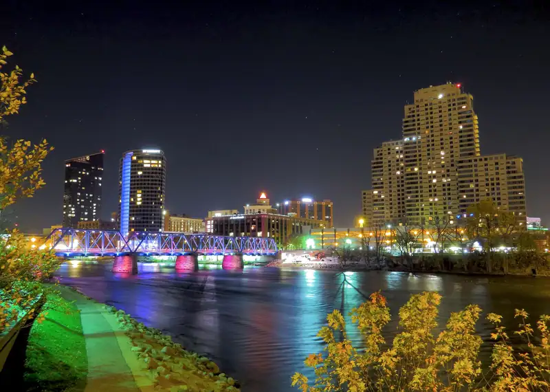 The lit-up Blue Bridge and downtown towers reflected in the river