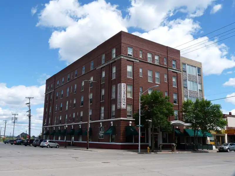 A tall historic brick hotel on a downtown corner