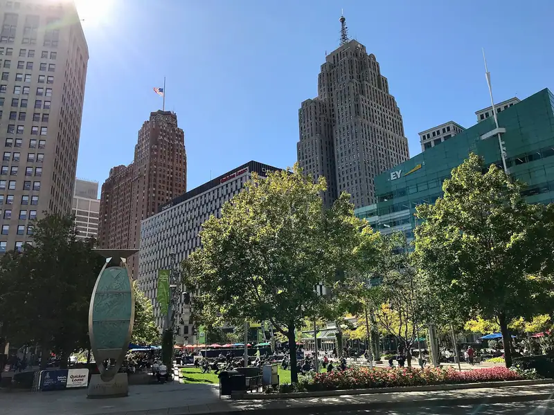 Downtown towers above a tree-lined street