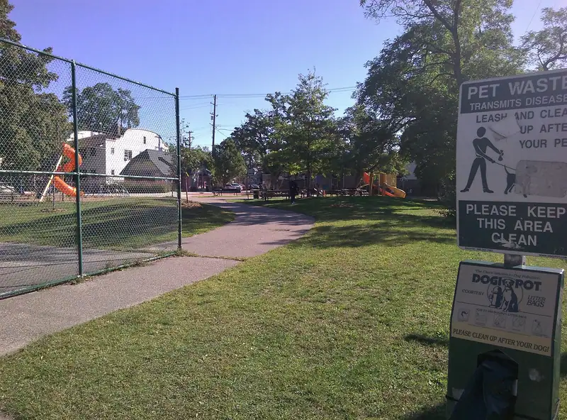 A small neighborhood park with trees and a path