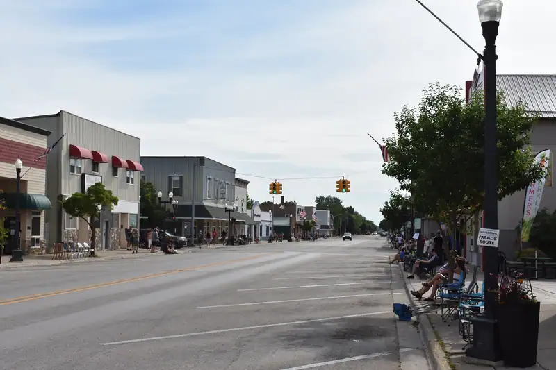 A downtown street with flags and storefronts