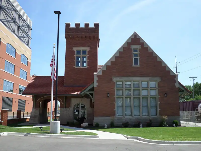 A historic brick railroad depot with a tower