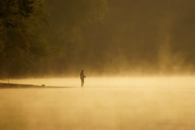 Misty golden September morning over water