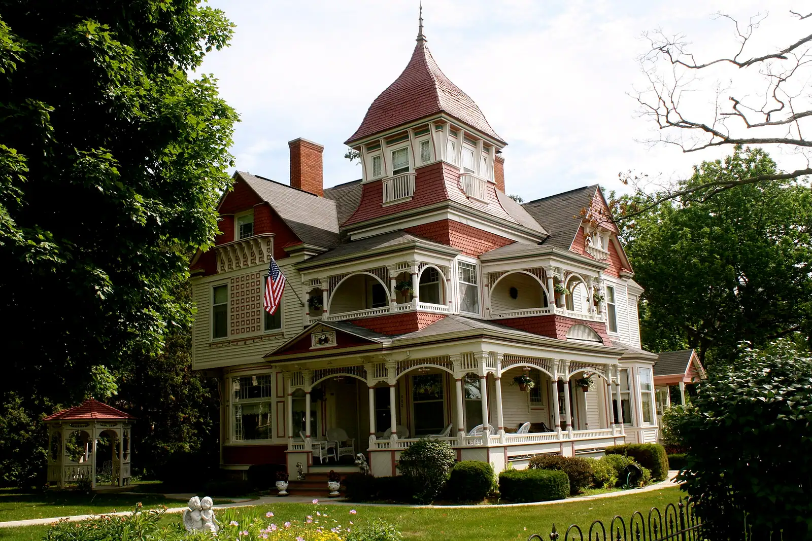 An ornate Queen Anne Victorian house with a turret