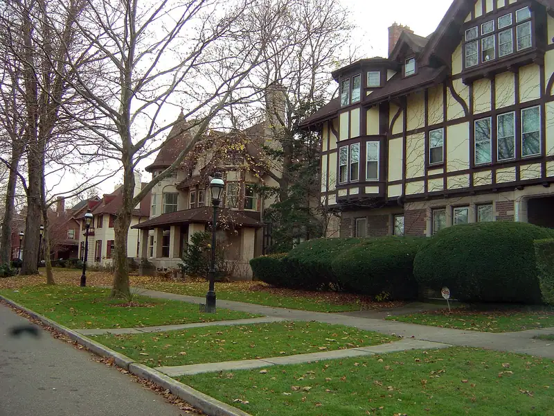 Historic Tudor-style houses with front lawns