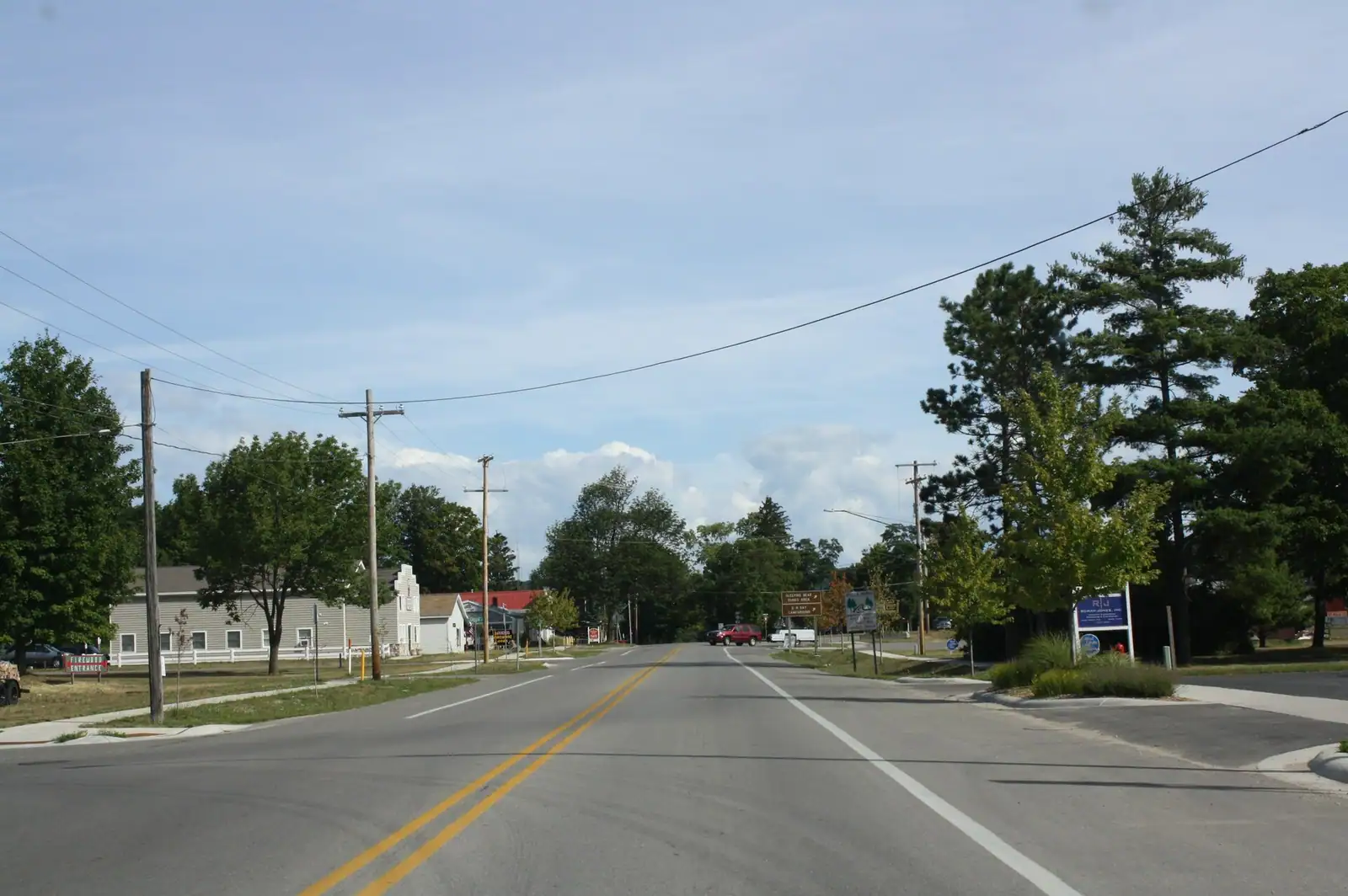 A quiet village road lined with trees