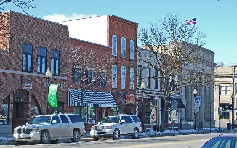 A row of historic commercial buildings under a blue sky