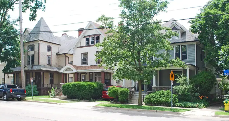 A large Victorian house with a turret and porch