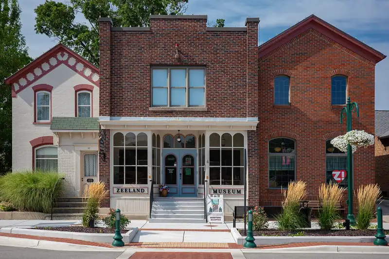 The historic brick Zeeland Museum with flowers out front